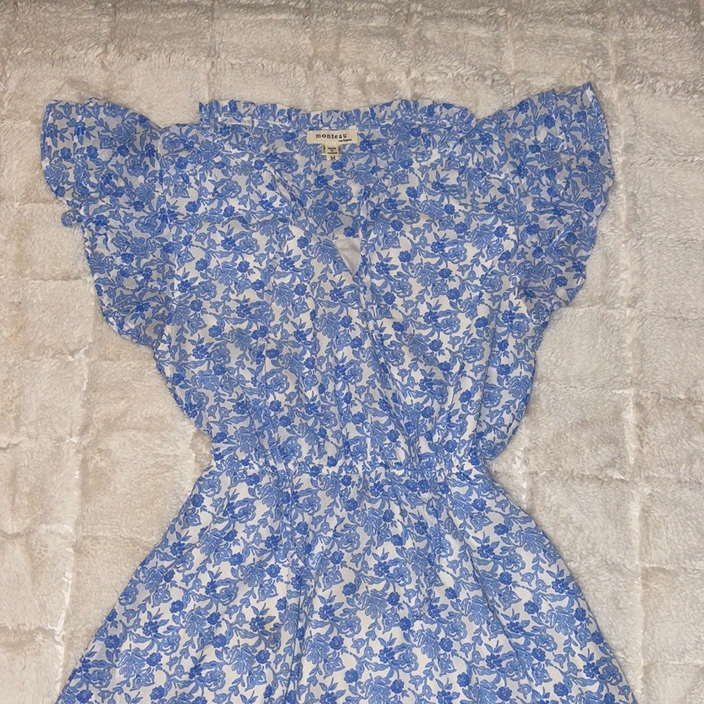 Blue and white floral design, ruffled shoulders and neck-hem with a v-neck